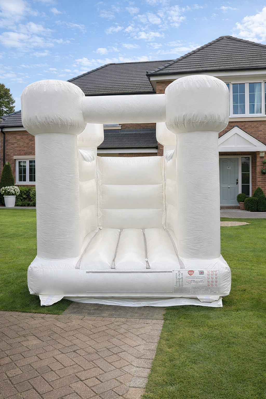 Clean all-white luxury bouncy castle set up outdoors