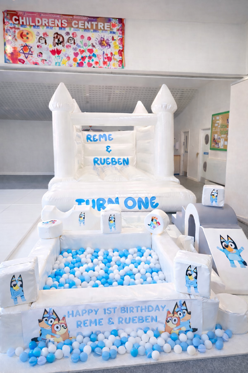 Bluey themed birthday party with white bouncy castle and soft play