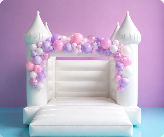 Pastel pink and purple balloon garland on a white bouncy castle