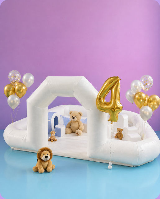Personalised white soft play and inflatable setup with gold number four balloon