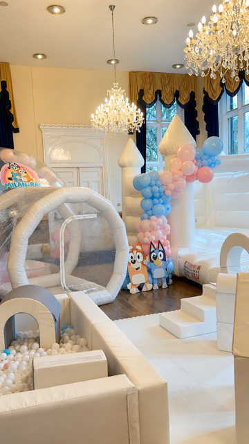 White bouncy castle, bubble house and soft play rental package with pastel balloons
